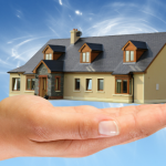 house-in-hand-with-blue-background
